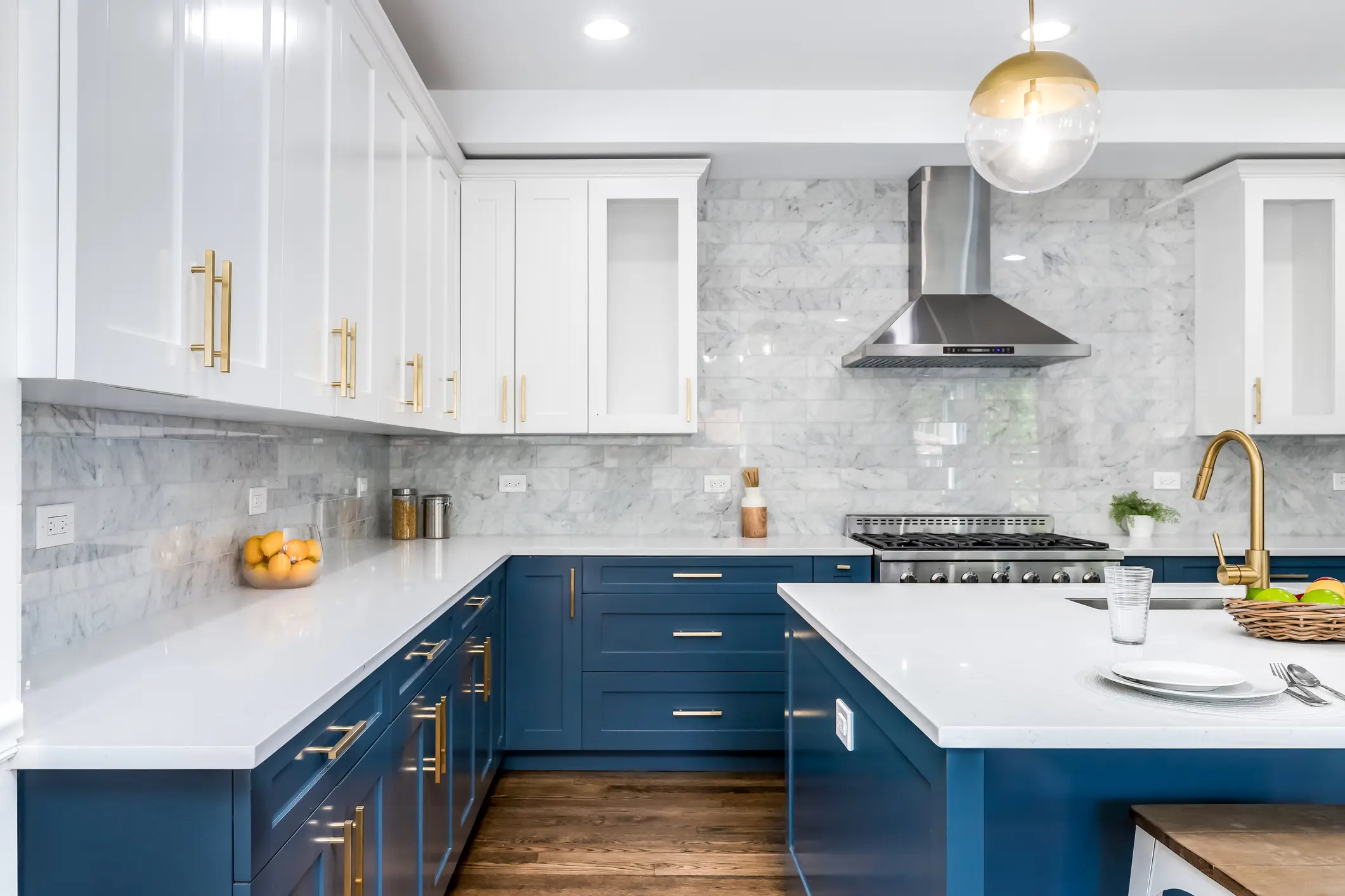 Modern kitchen with blue and white cabinets.